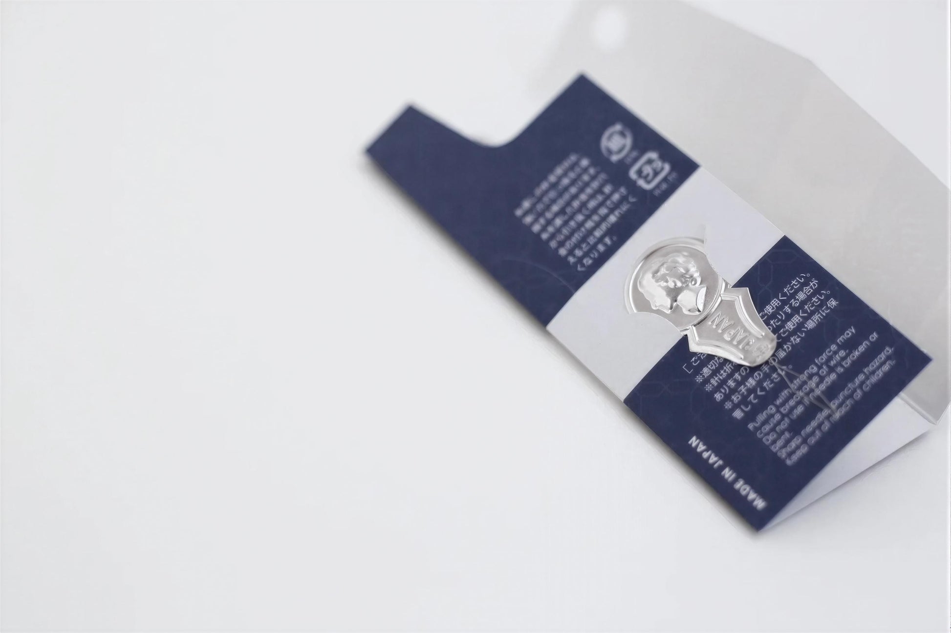 a close-up view of a blue and white label with text and a silver emblem.