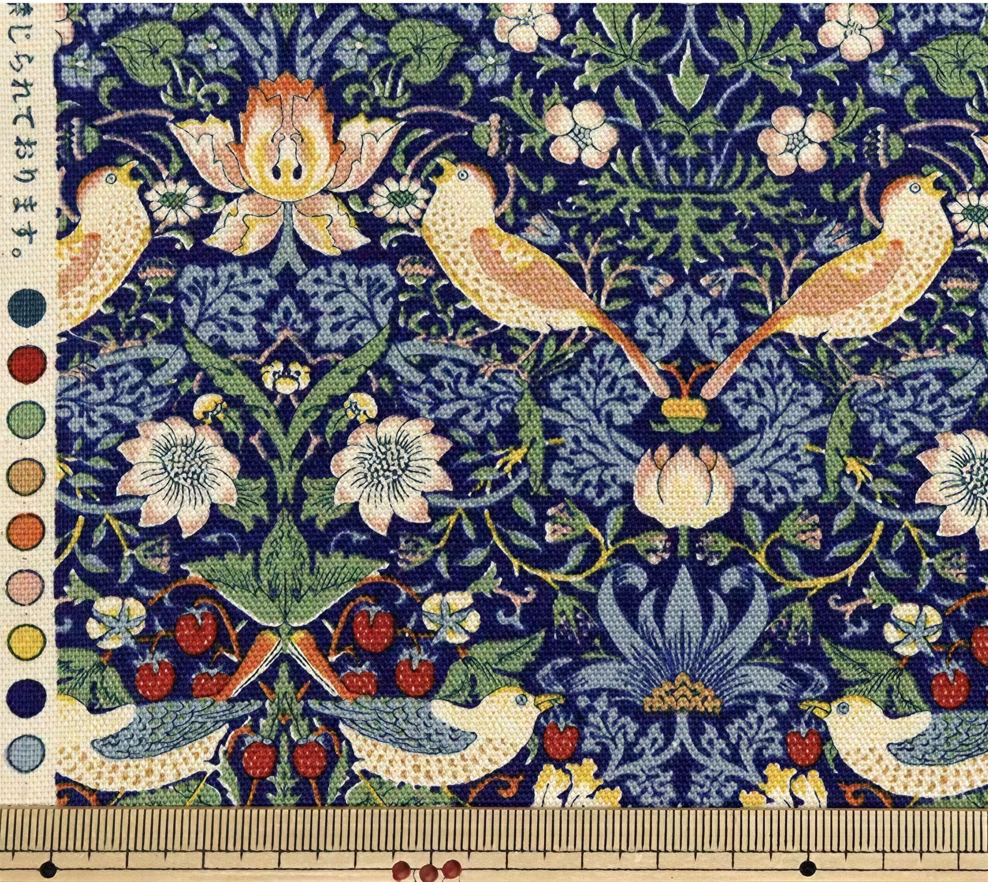 The image is a detailed tapestry featuring a variety of birds, flowers, and berries in a vibrant, colorful design.