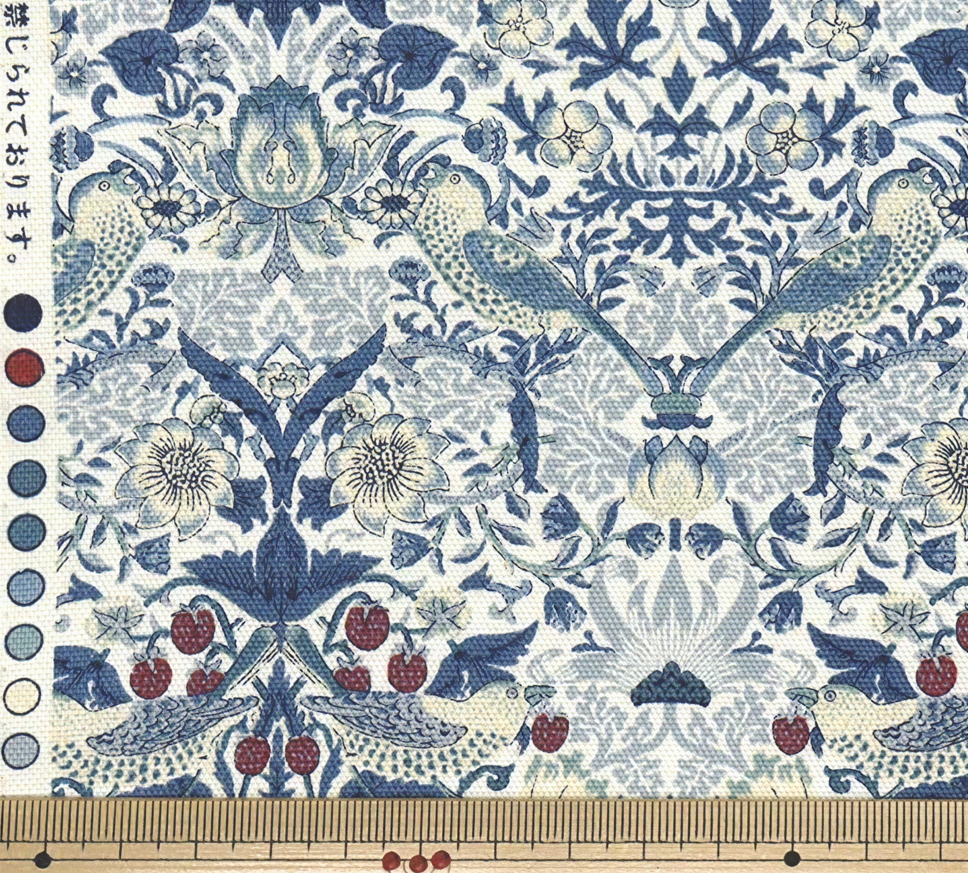 a repeating pattern of blue and white floral designs with birds and berries. The pattern is intricate and detailed, showcasing the craftsmanship and artistry of the design.