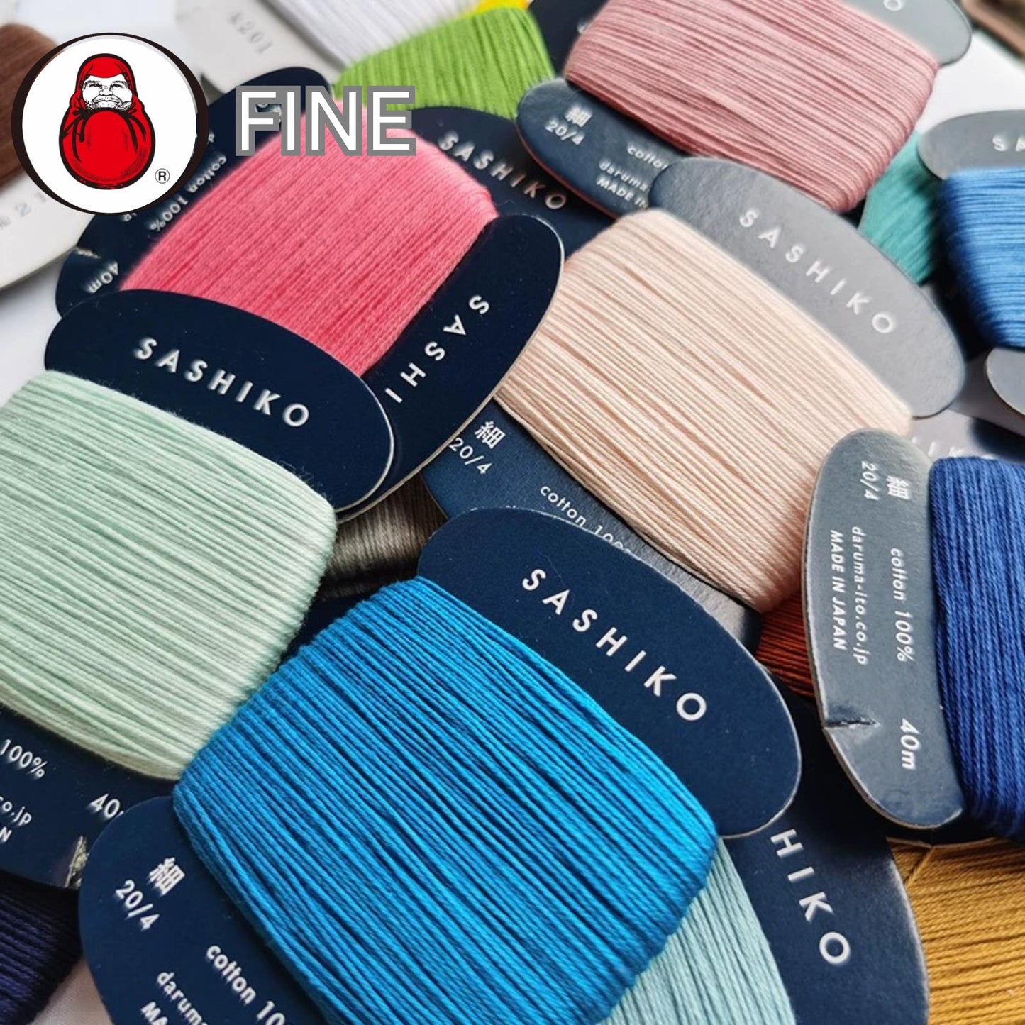 a collection of colorful spools of thread, each labeled with the brand name "SASHIKO" in white text. The spools are arranged in a way that allows for a clear view of the brand names and thread colors.