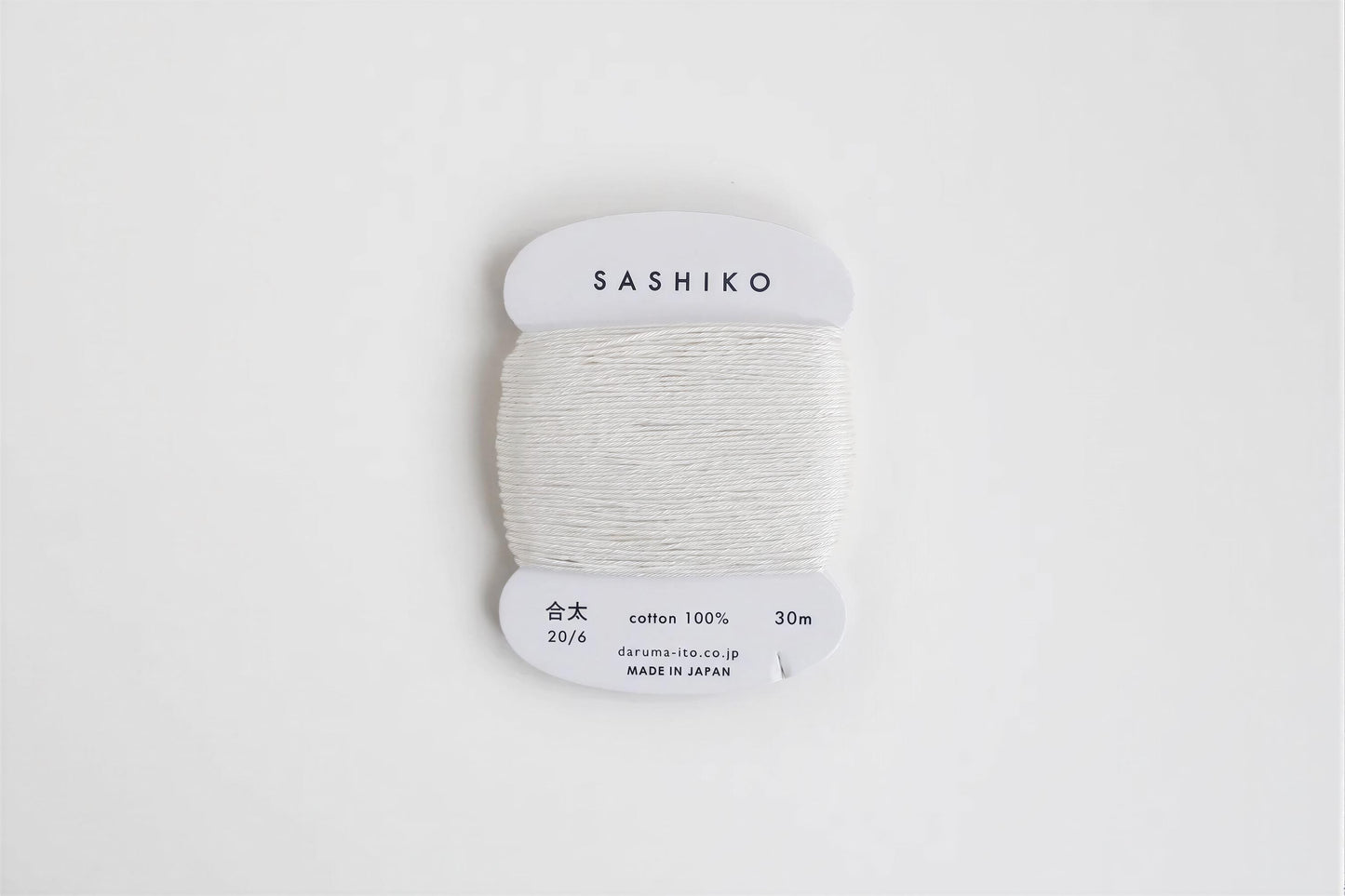 A spool of white thread labeled "SASHIKO" against a white background.
