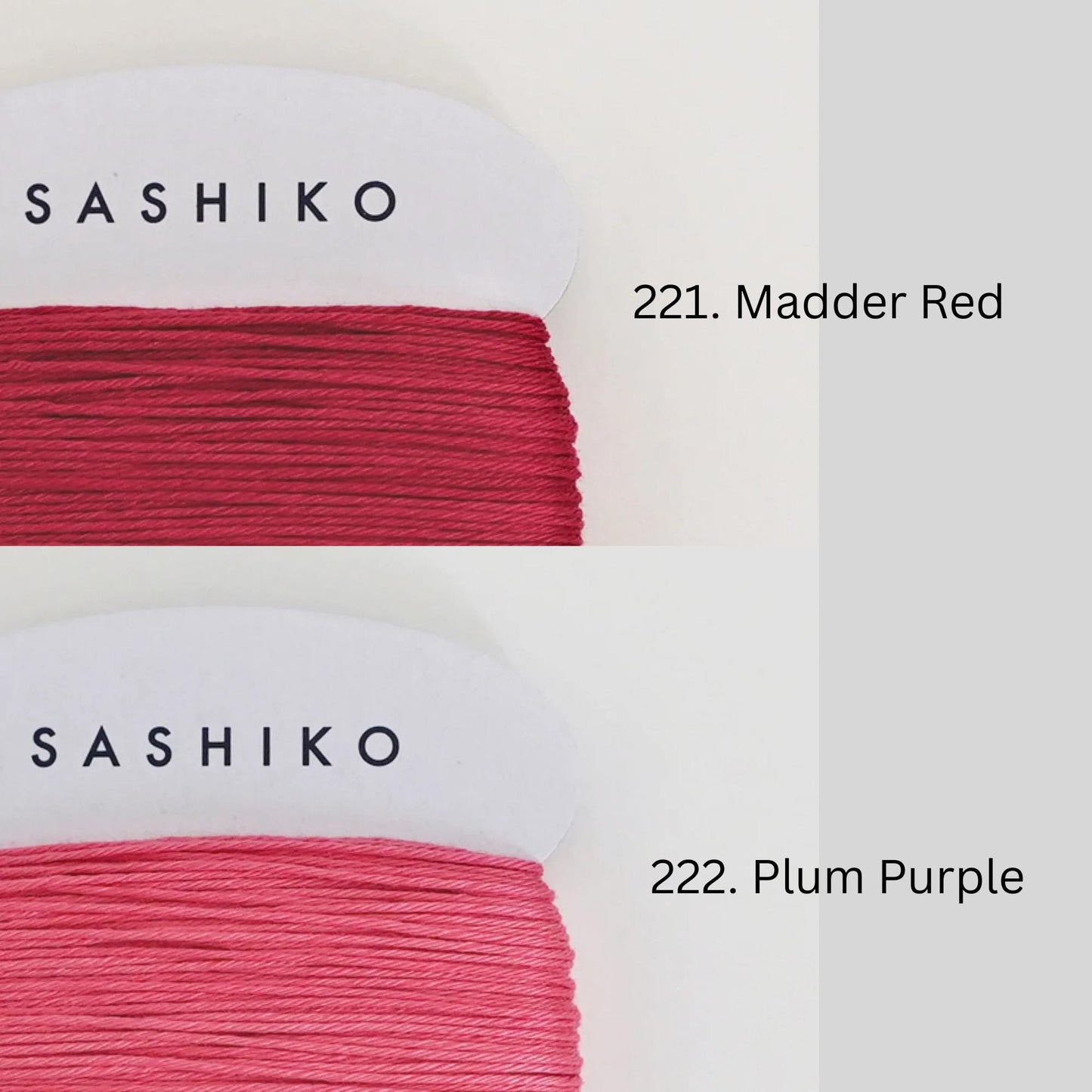 two spools of thread, each with a different color: one is a vibrant red and the other is a more subdued plum purple. The text next to each spool identifies the color of the thread as follows: - On the red spool: "SASHIKO" - On the plum purple spool: "222. Plum Purple"
