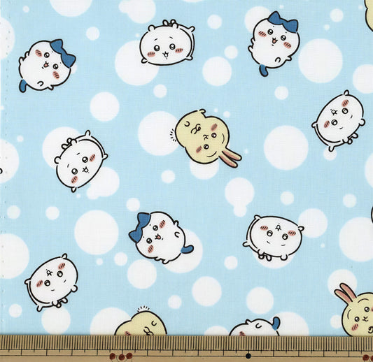 a pattern of cartoon-style animals, including rabbits, against a light blue background with white polka dots.