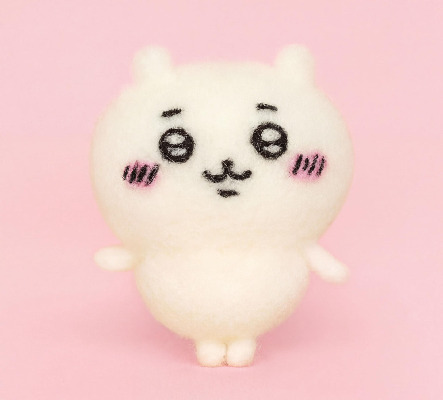 A cute, white plush toy with large eyes and a small nose is standing on a pink background.