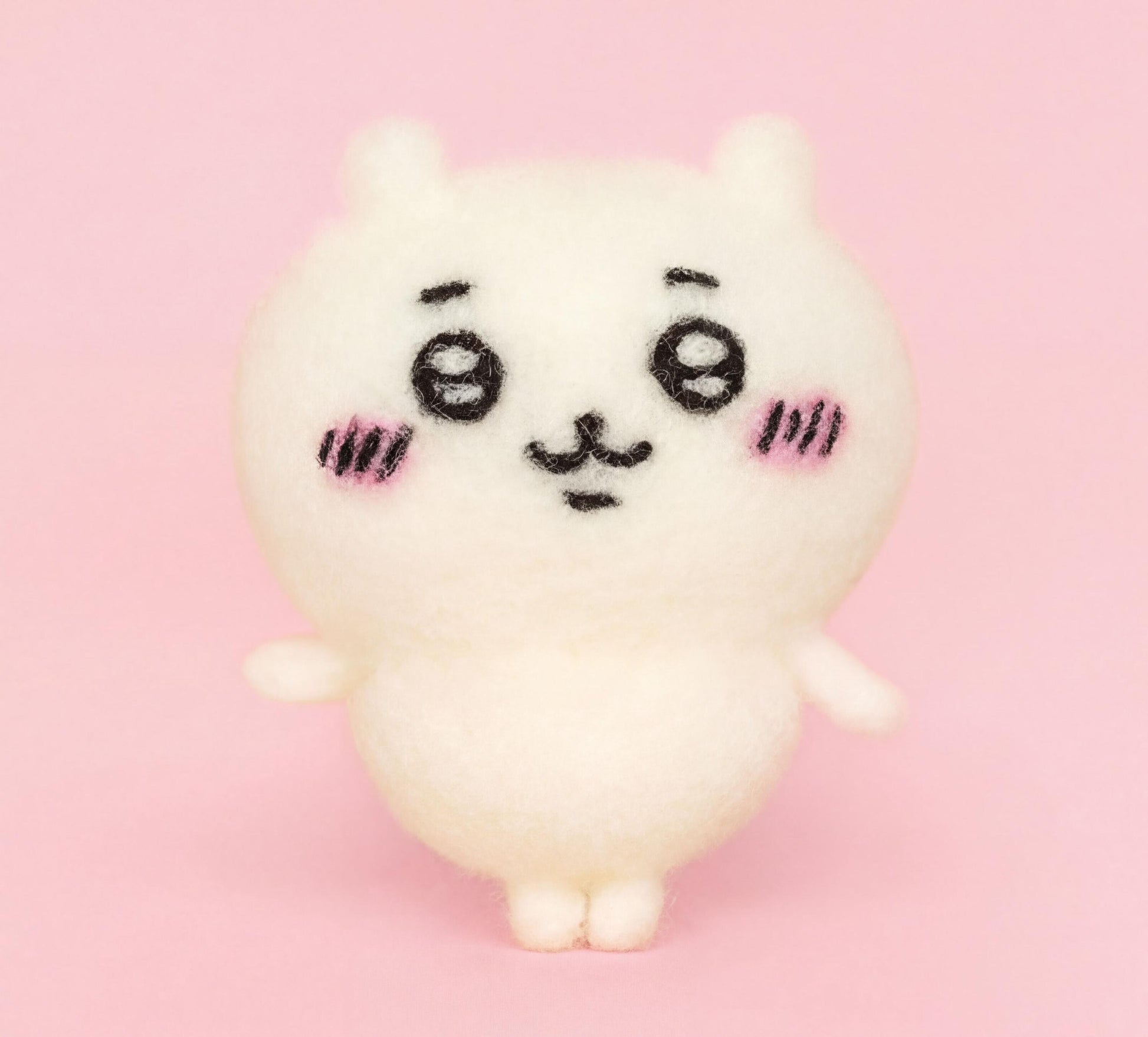 A cute, white plush toy with large eyes and a small nose is standing on a pink background.