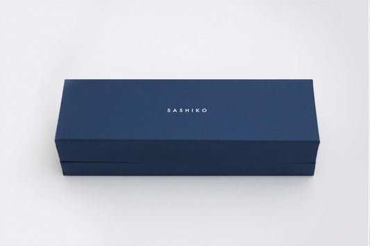 A navy blue rectangular box with the word "SASHIKO" printed on it.