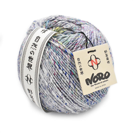 A ball of multicolored yarn with a label that includes Japanese text and a logo.