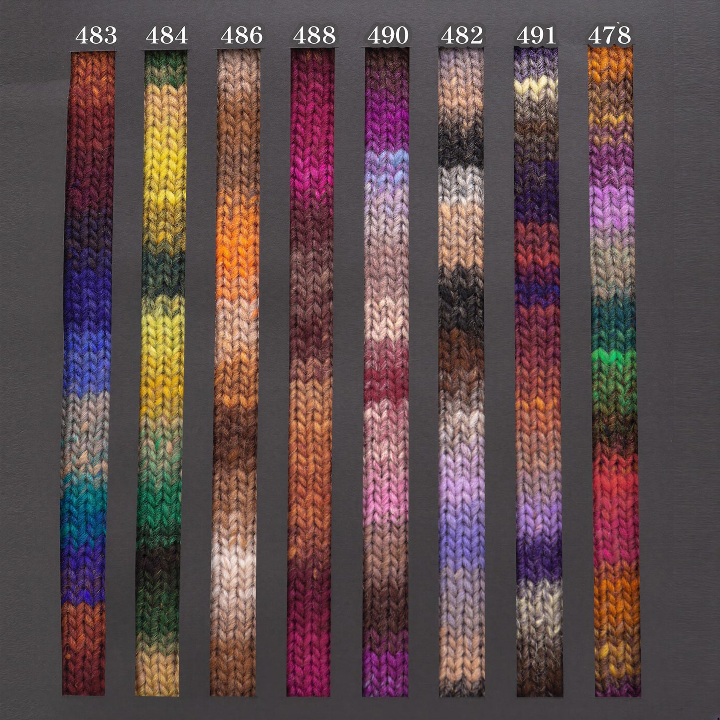 a collection of nine knitted or crocheted fabric swatches, each with a unique color and pattern. The swatches are arranged in a row, showcasing a variety of colors and textures.