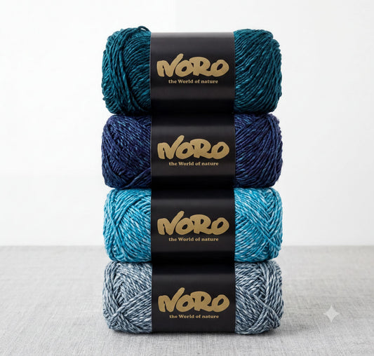 a stack of four balls of yarn, each with a black label that displays the text "NERO the World of nature".