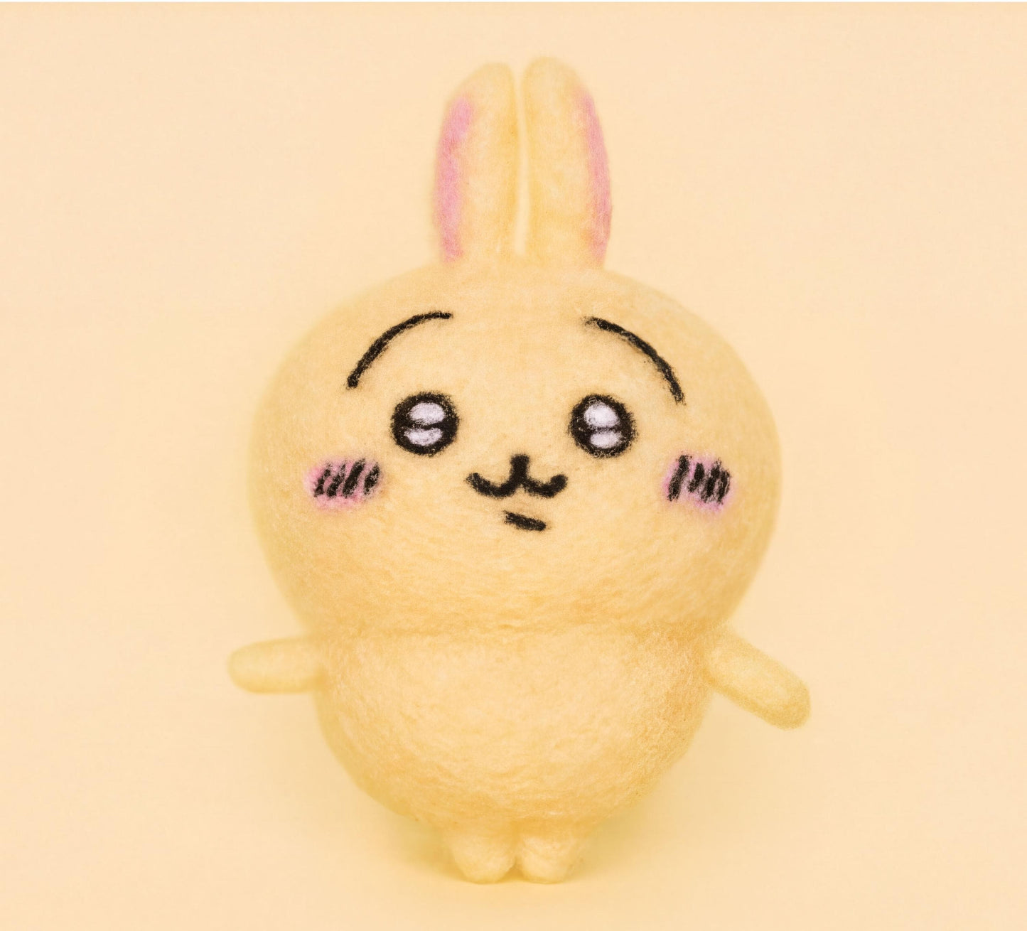 A cute, yellow plush rabbit with a pink nose and ears, with a small smile on its face, is the main subject of the image.