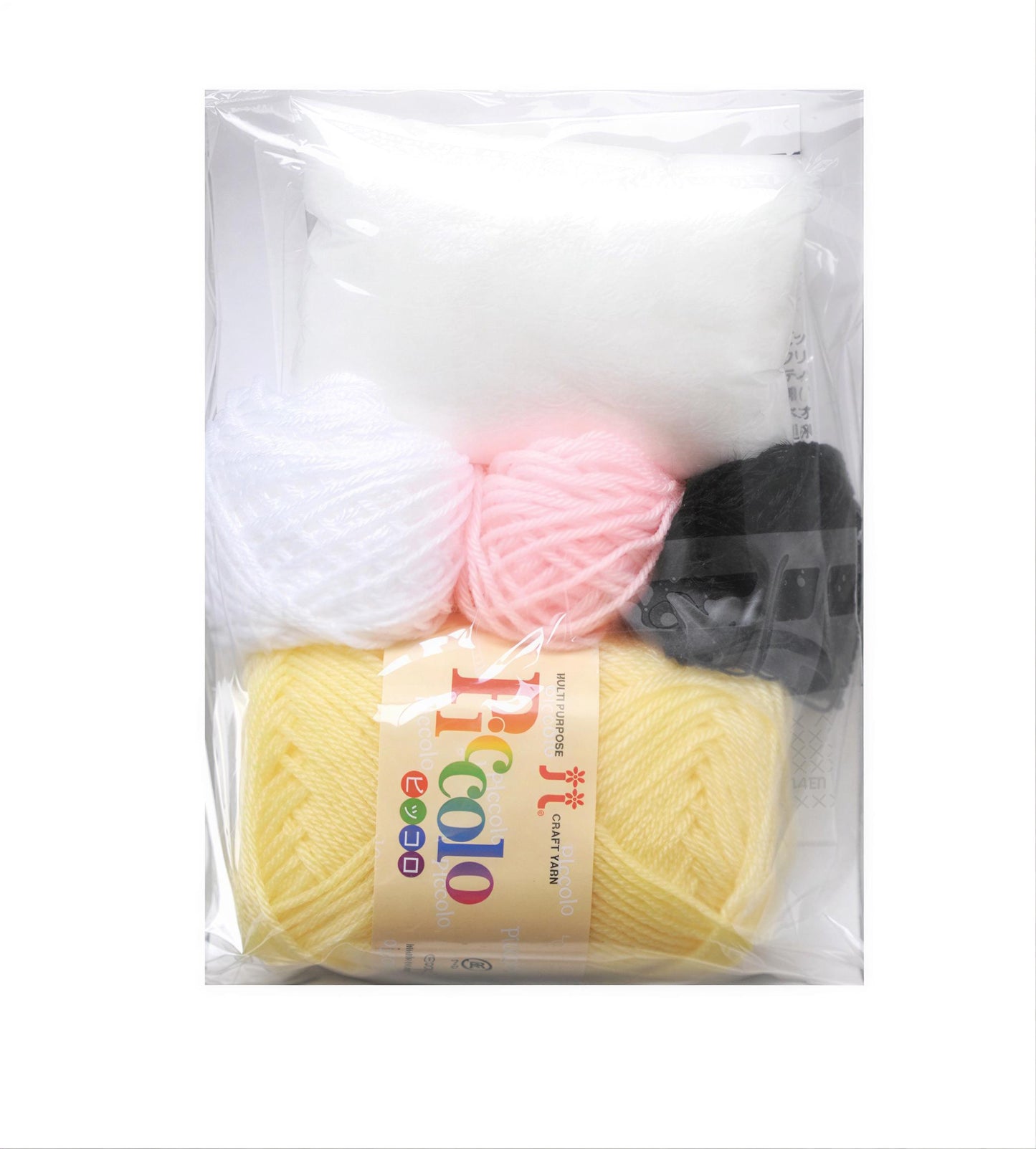 A package containing various yarn colors, including white, pink, and black, along with some other craft supplies.