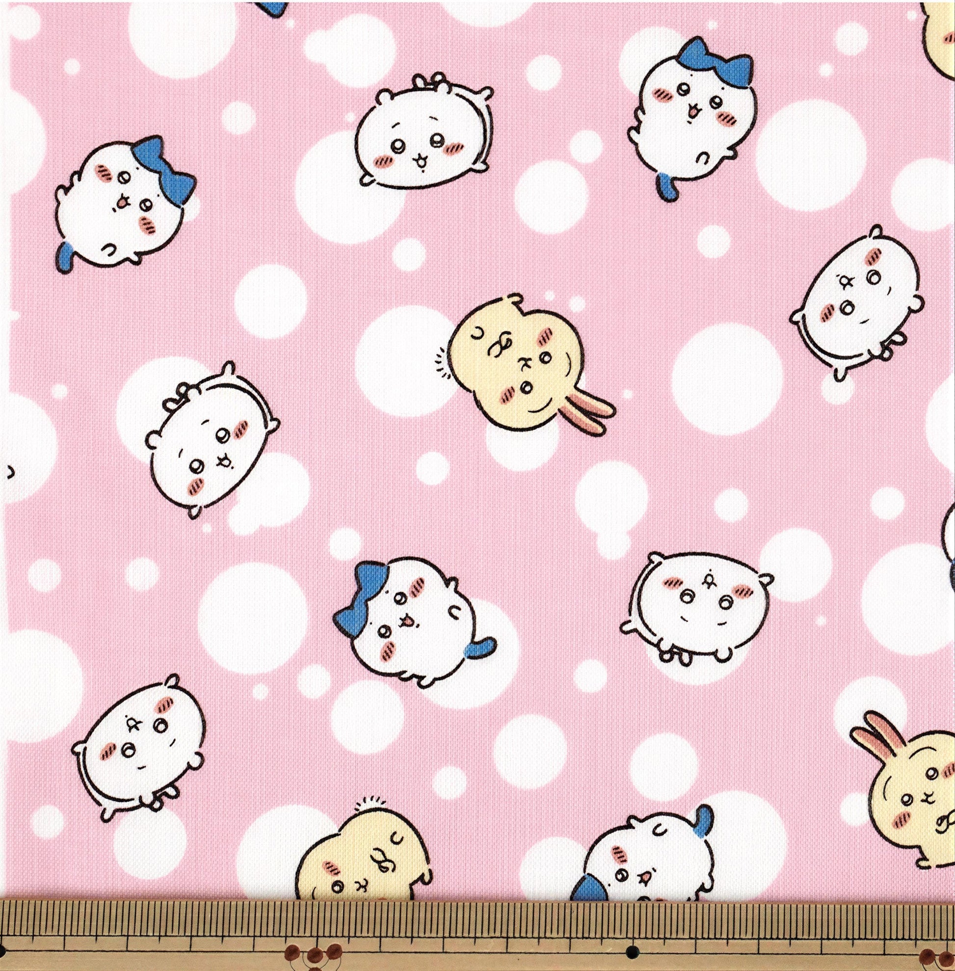 a pink background with white polka dots, and it contains a variety of cartoon-style animal faces, including cats, dogs, and rabbits, all with expressive eyes and noses.