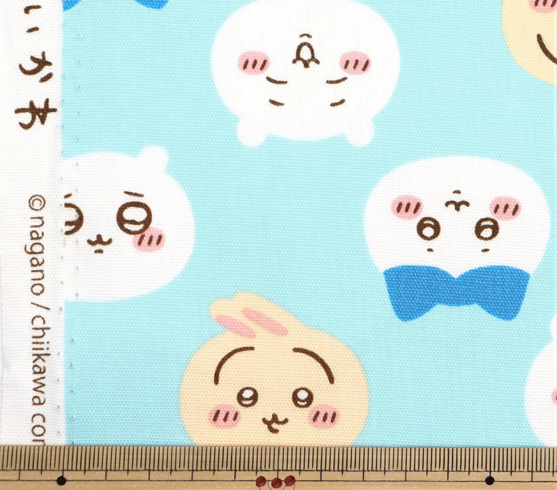 a collection of cartoon-style faces with exaggerated features, such as large eyes, big noses, and wide smiles, set against a light blue background.