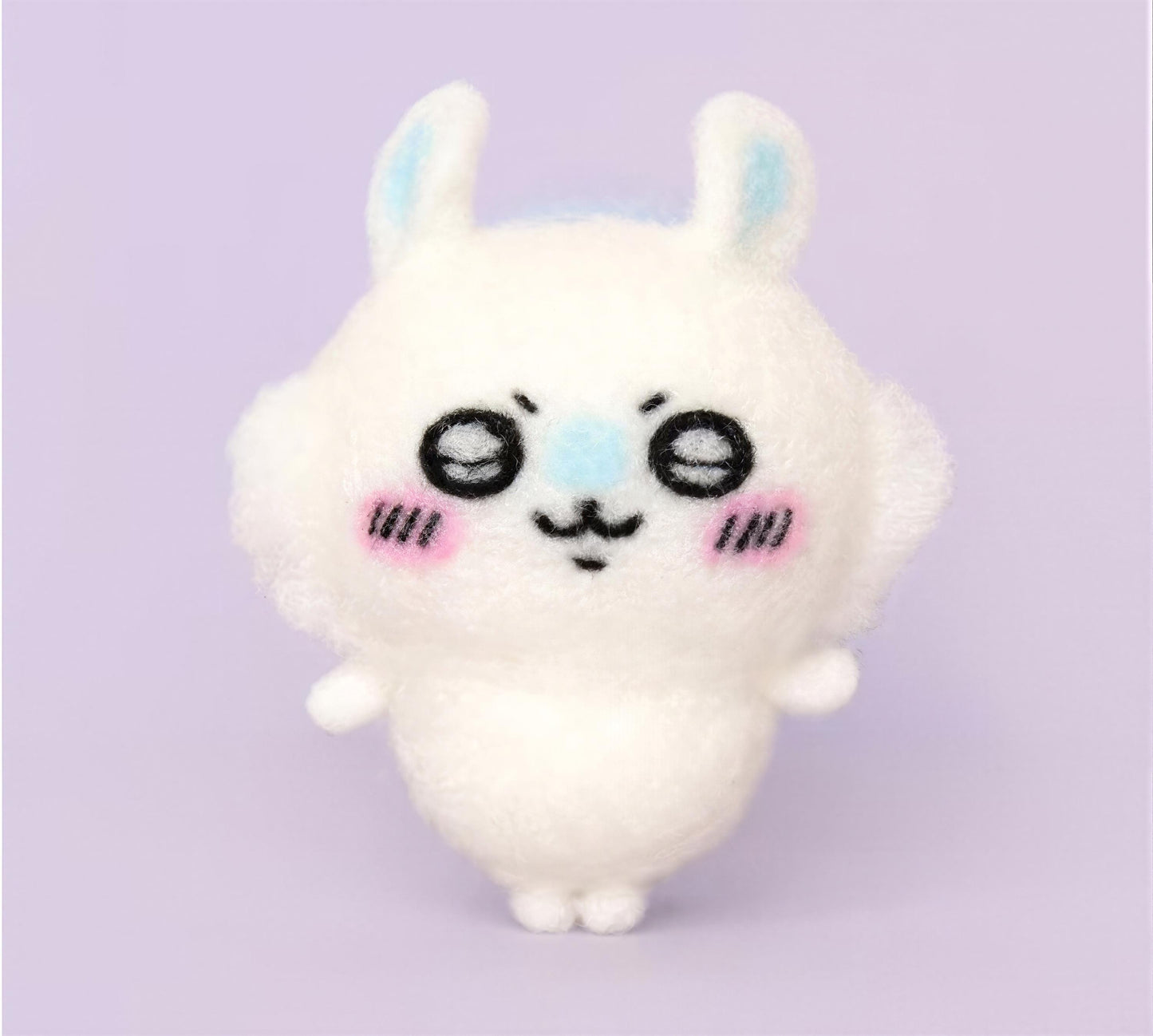 A cute, plush rabbit toy with large eyes and a small nose, standing upright against a purple background.