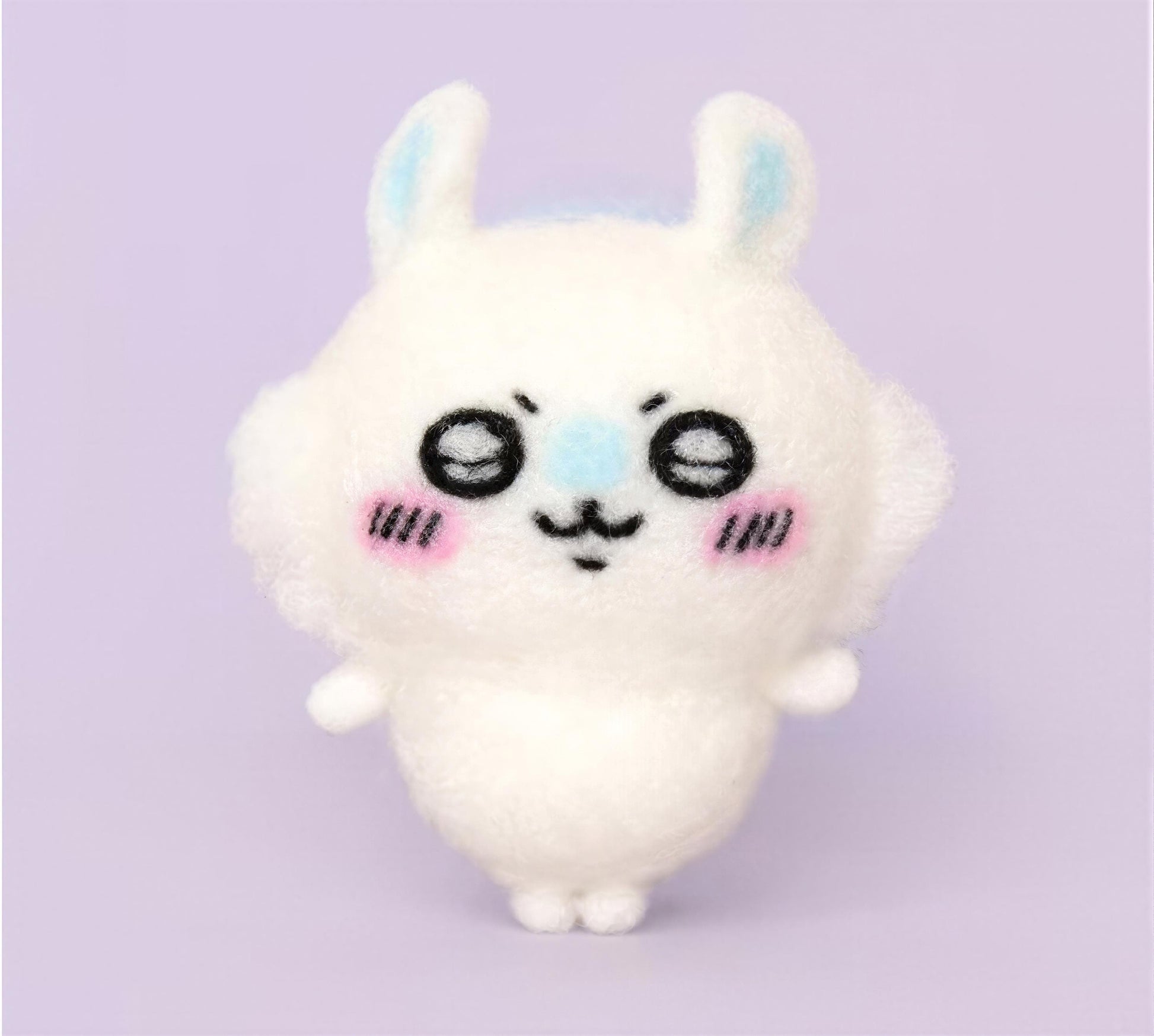 A cute, plush rabbit toy with large eyes and a small nose, standing upright against a purple background.