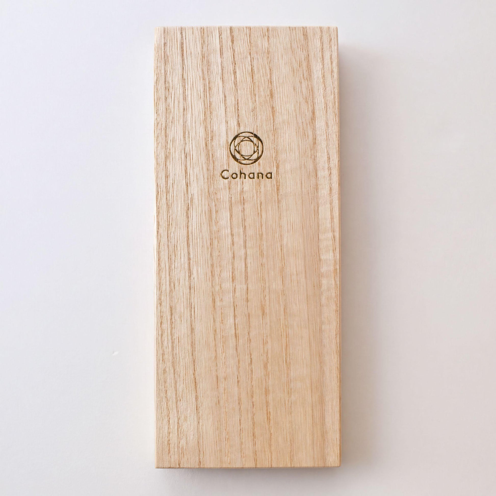 A wooden object with a logo on it, placed against a white background.