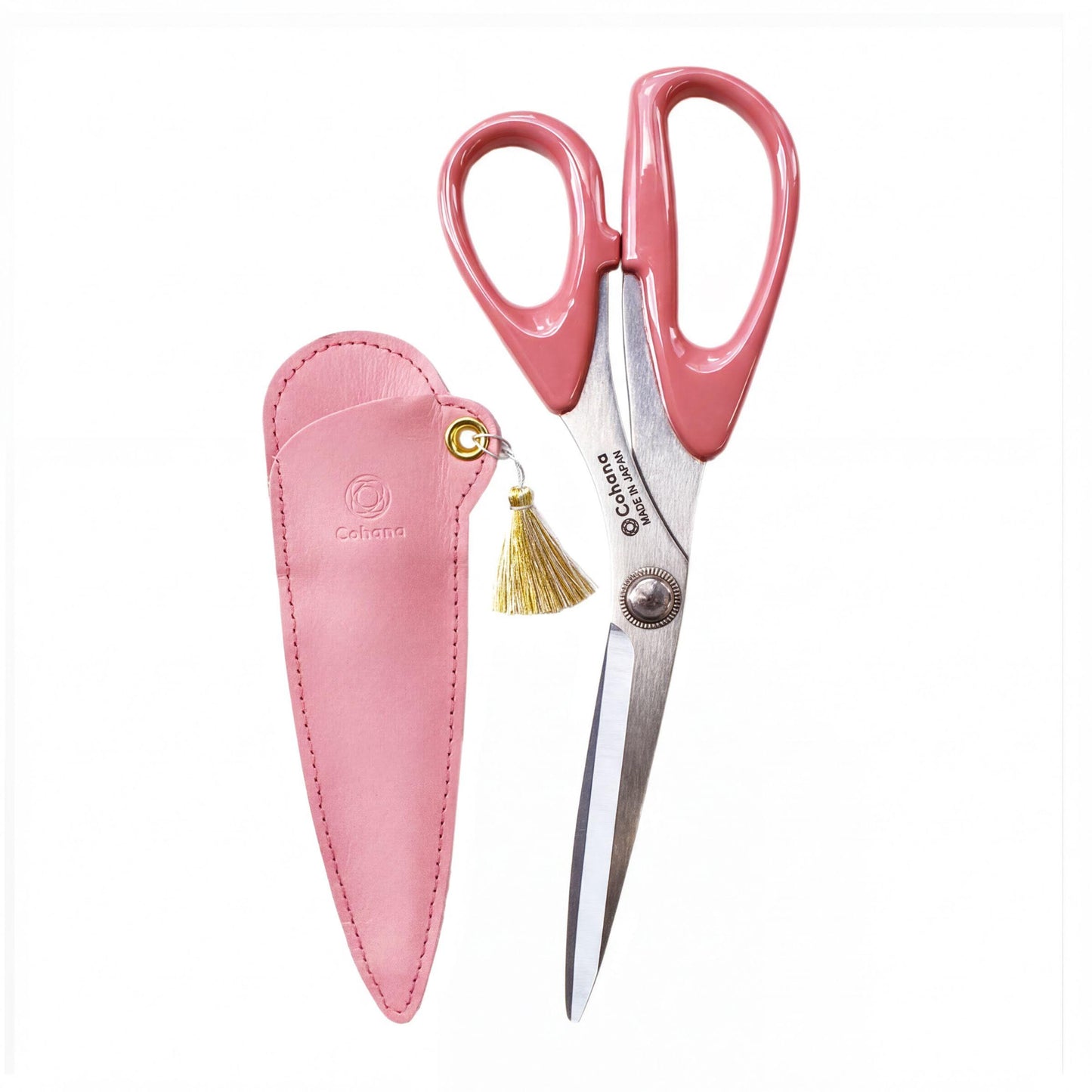 A pair of pink scissors with a pink leather case and a gold tassel attached.