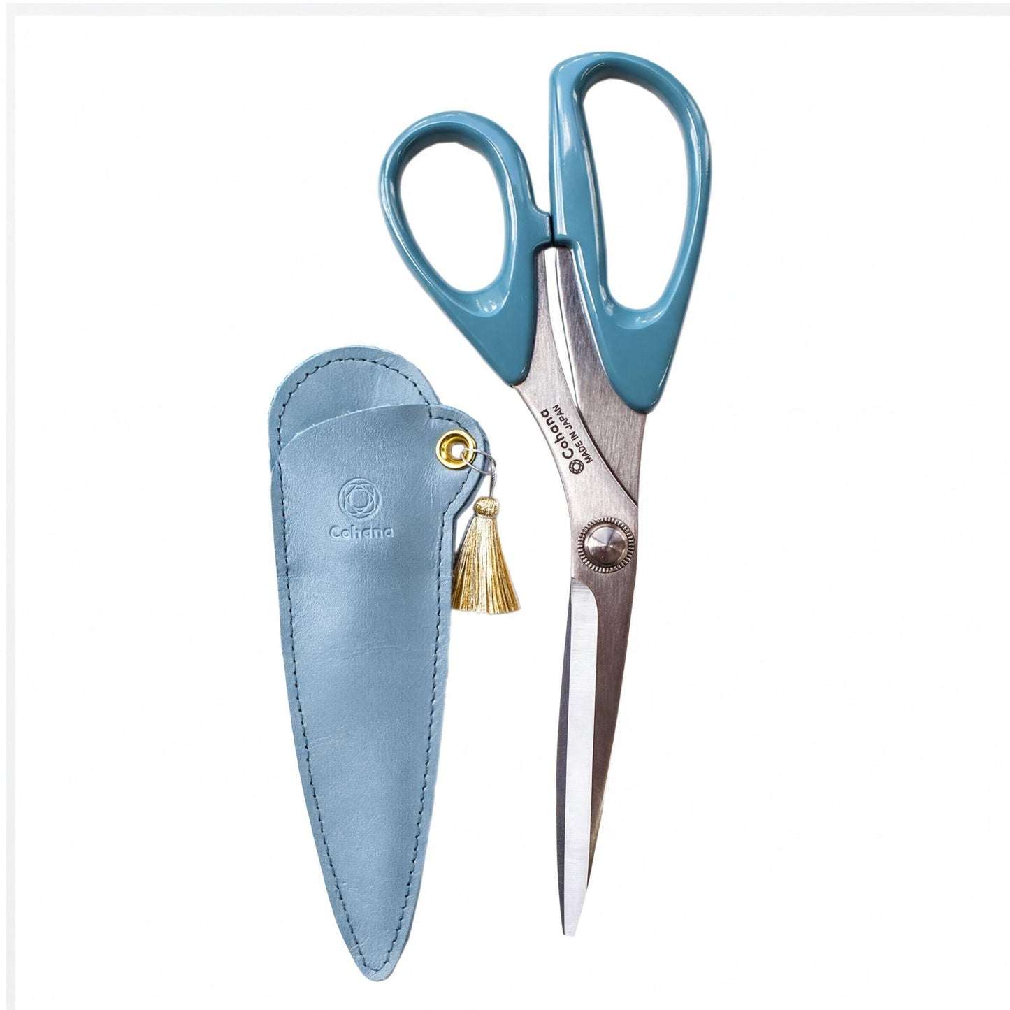 A pair of blue-handled scissors with a tassel hanging from the handle, placed next to a matching blue leather case.
