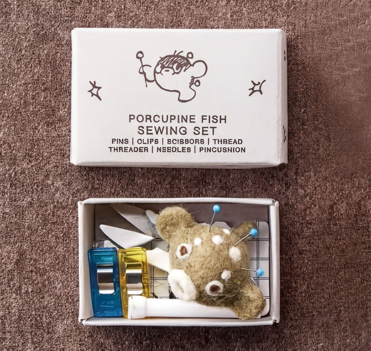 Porcupine Fish Sewing Set box with sewing tools inside a small box containing a stuffed animal.