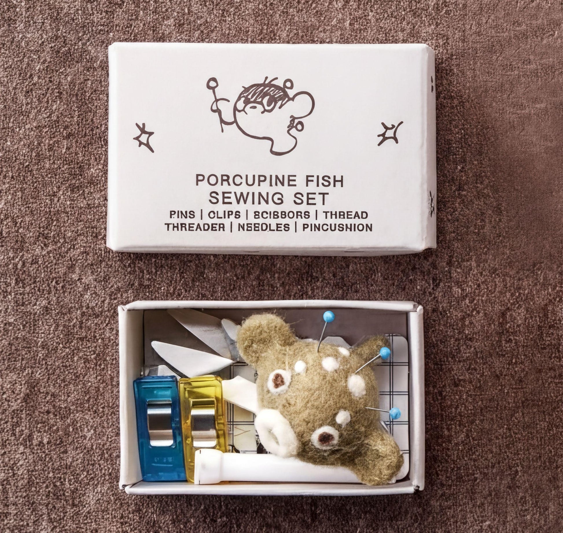 Porcupine Fish Sewing Set box with sewing tools inside a small box containing a stuffed animal.