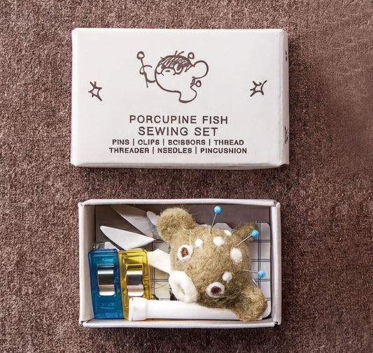 Porcupine Fish Sewing Set box with sewing tools inside a small box containing a stuffed animal.