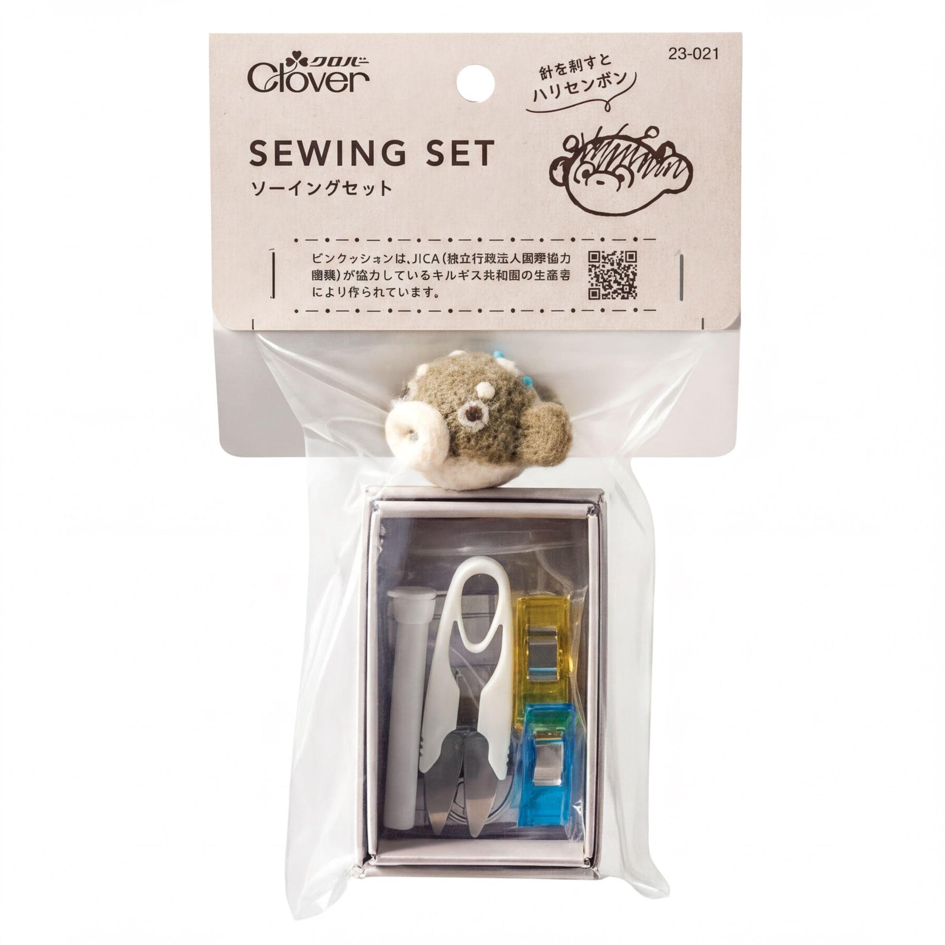 A sewing kit with a small stuffed animal fish toy inside a clear plastic bag.