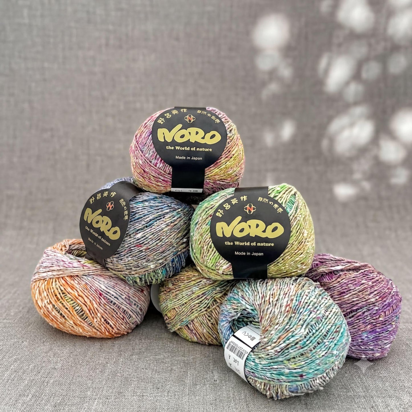 A collection of colorful yarn balls, each with a label that reads "Nero the World of nature".