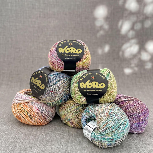 A collection of colorful yarn balls, each with a label that reads "Nero the World of nature".