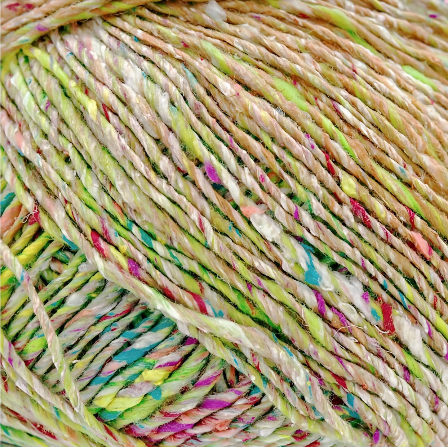 a close-up view of a ball of multicolored yarn, with the yarn's strands twisted together in a dense, tangled pattern.
