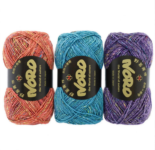 Three balls of yarn in different colors - red, blue, and purple - are displayed against a white background.