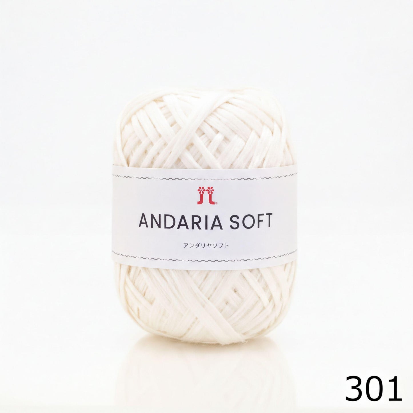 A ball of white yarn with a label that reads "ANDARIA SOFT" and "コーヒー" (Japanese for "yarn").