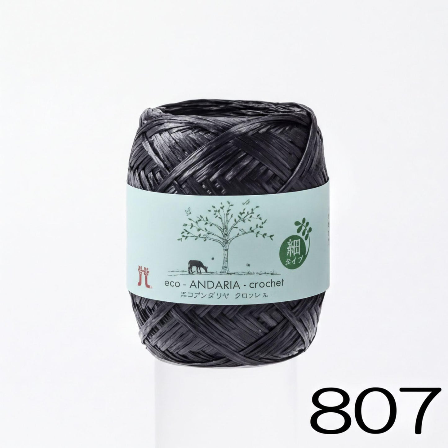 A spool of black yarn with a label that reads "eco. ANDARIA-crochet" and "atz" (which is Japanese for 'crochet').