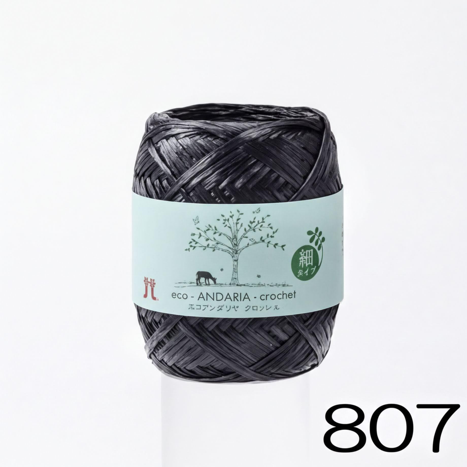 A spool of black yarn with a label that reads "eco. ANDARIA-crochet" and "atz" (which is Japanese for 'crochet').