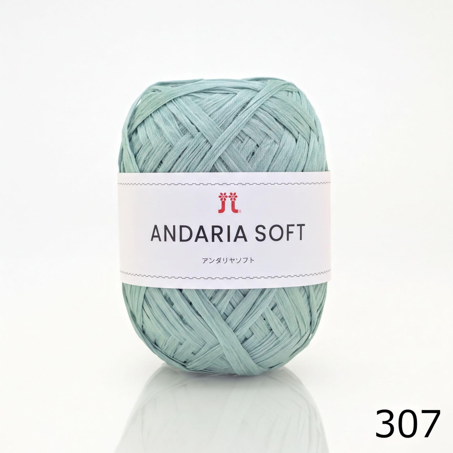 A ball of light blue yarn with a white label that reads "ANDARIA SOFT" and "コーヒー" (cotton).