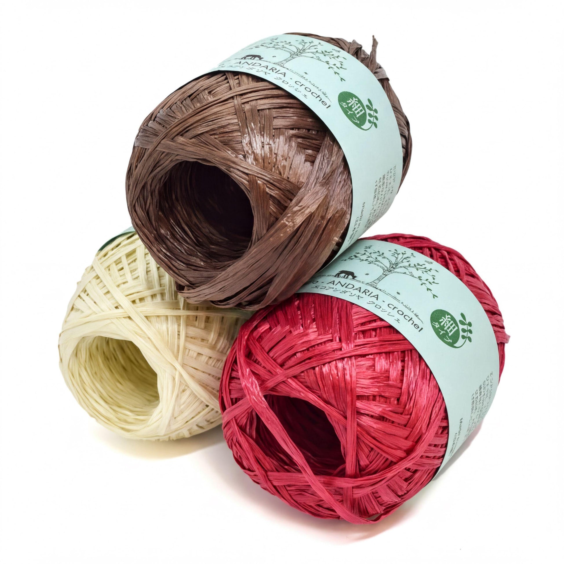 three spools of yarn, each with a different color: brown, white, and red.