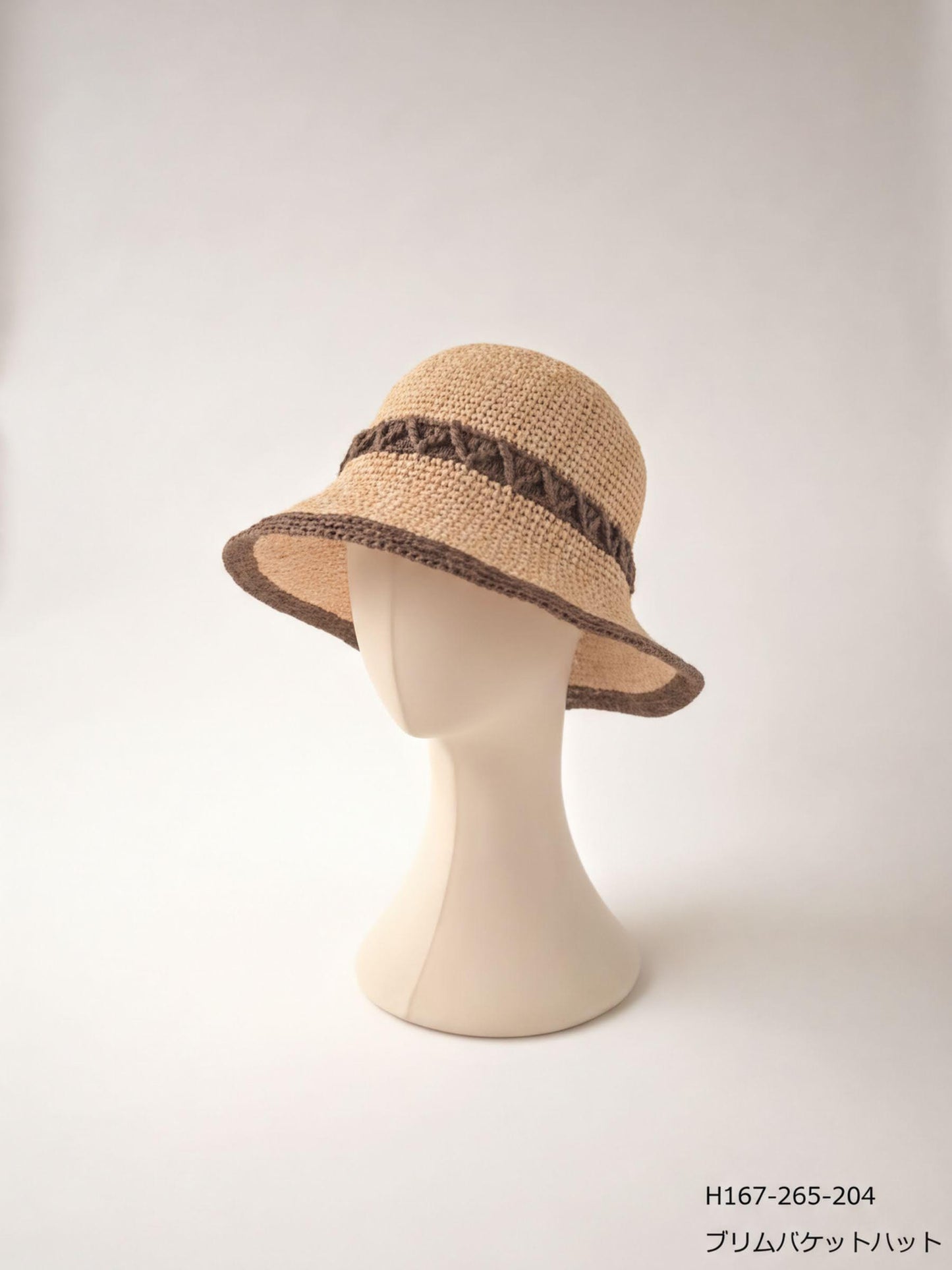 A beige crocheted hat with a brown trim, displayed on a mannequin head against a plain white background.