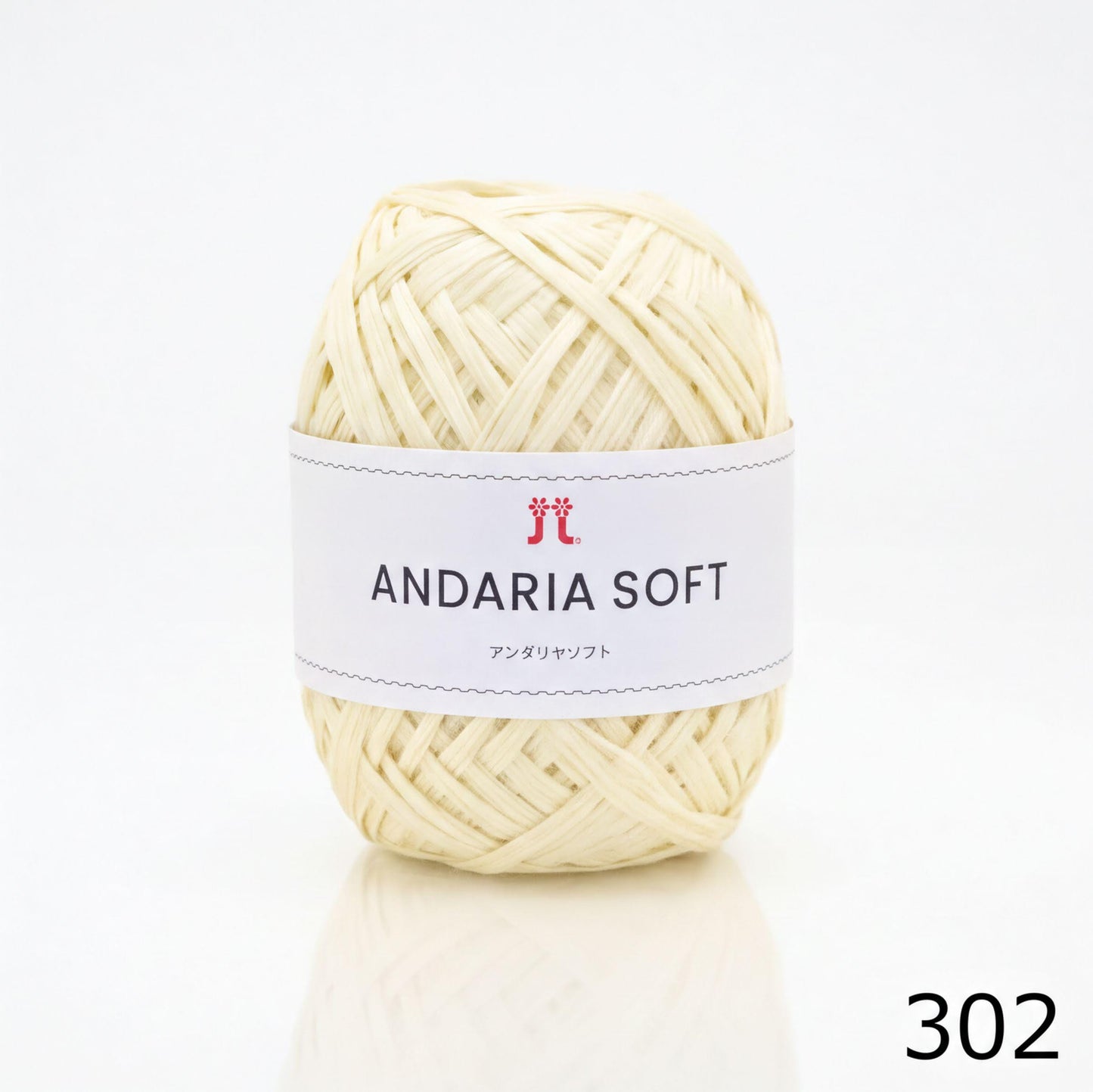 A ball of white yarn with a label that reads "ANDARIA SOFT" and "コーヒー" (Japanese for "yarn").