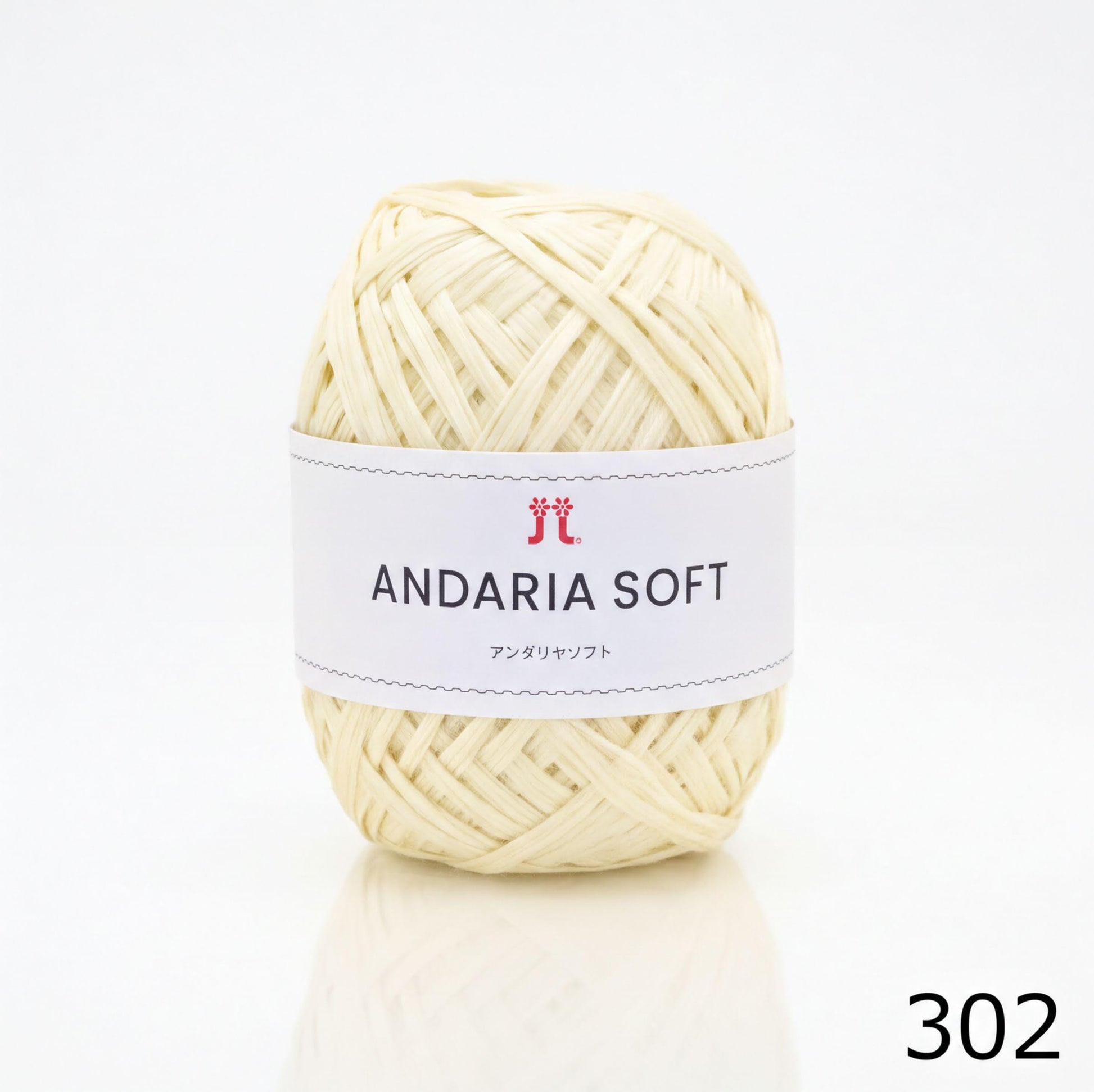 A ball of white yarn with a label that reads "ANDARIA SOFT" and "コーヒー" (Japanese for "yarn").