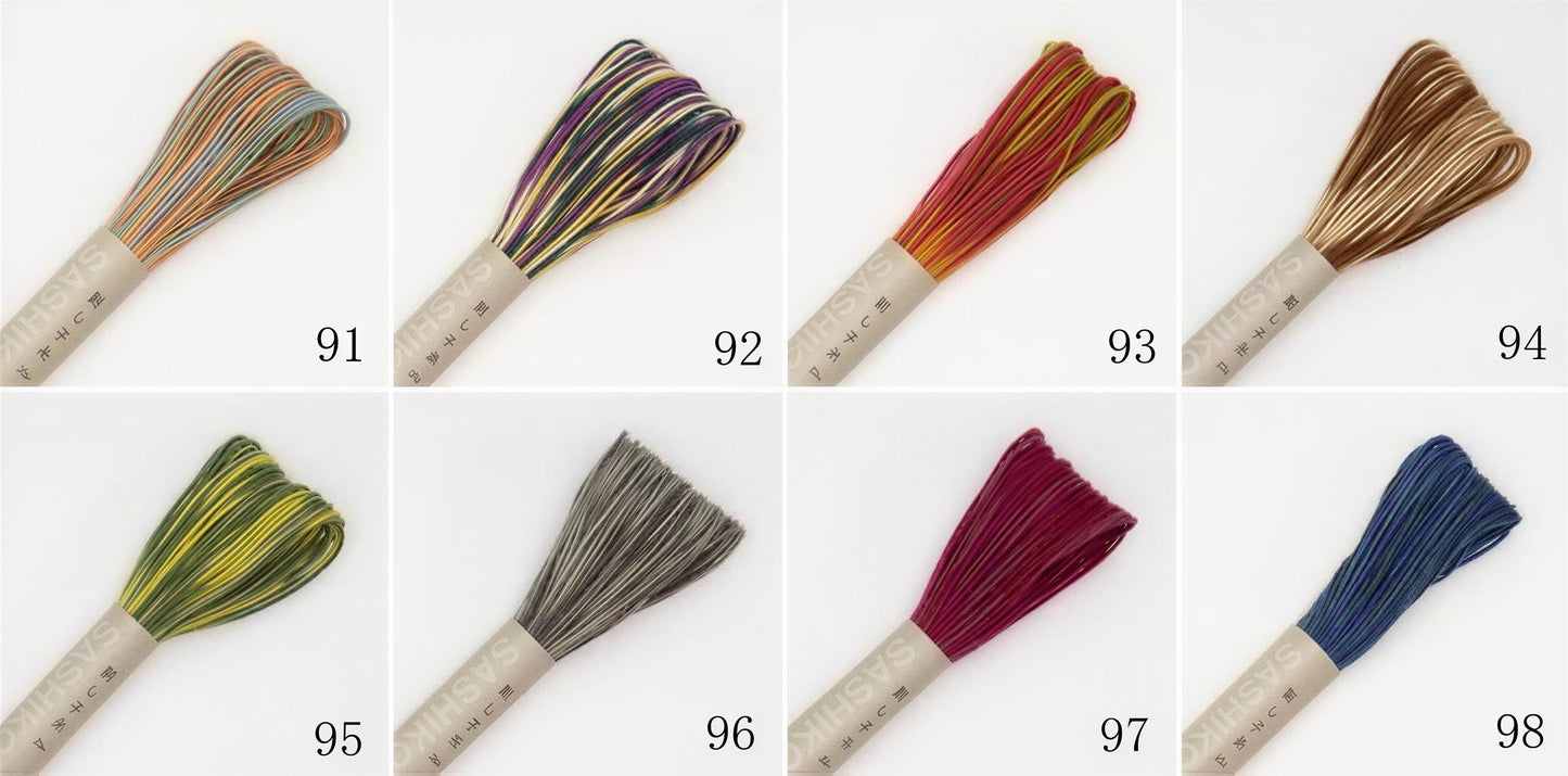 a collection of six different spools of thread, each with a unique color and pattern, arranged in a grid-like pattern.