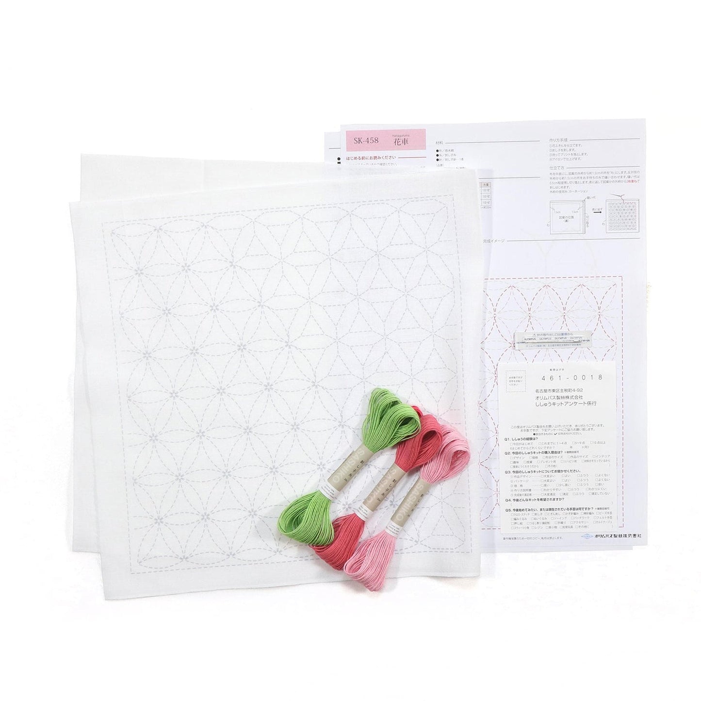 a sewing kit with a white square pattern, green and pink embroidery floss, and instructions for a sewing project.