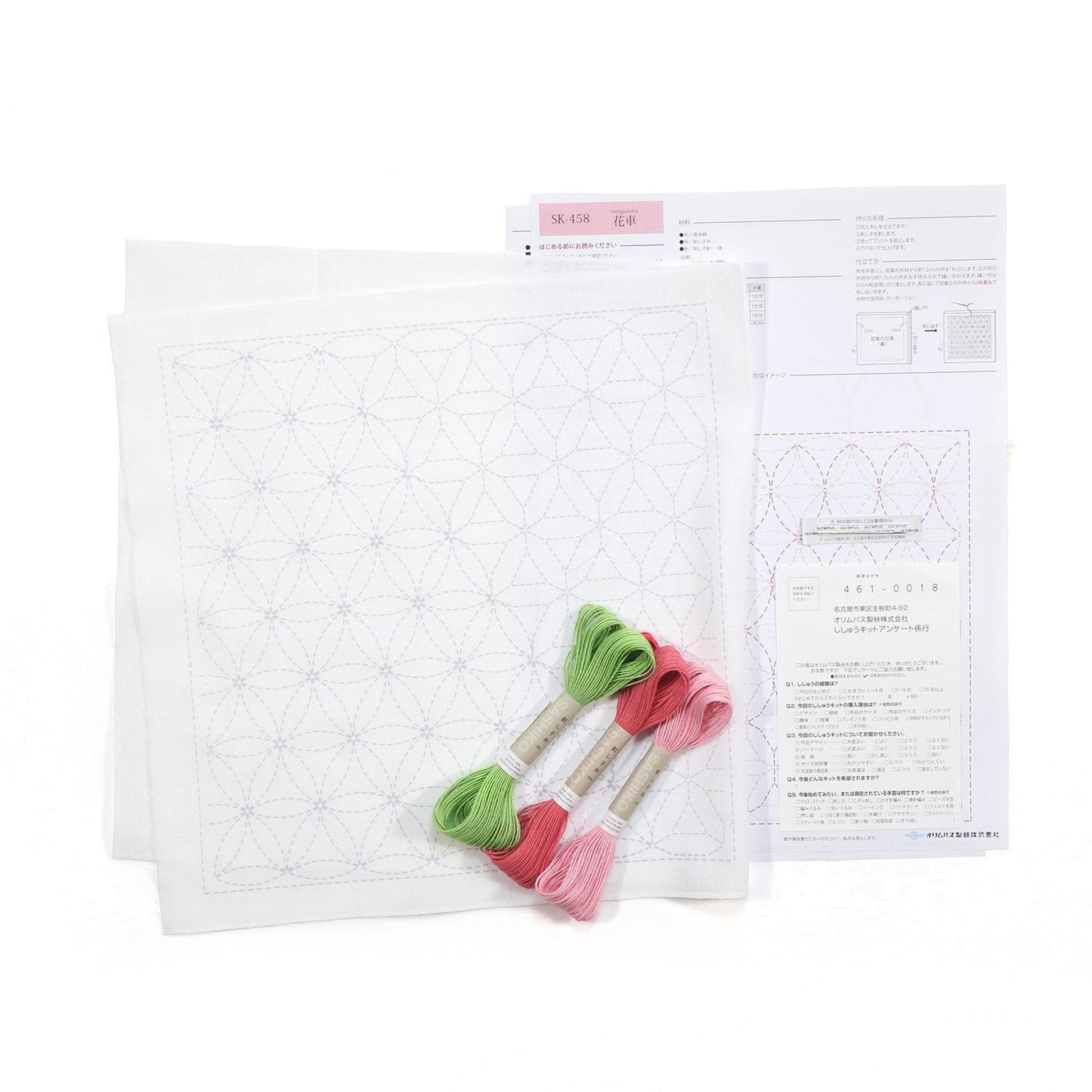 a sewing kit with a white square pattern, green and pink embroidery floss, and instructions for a sewing project.