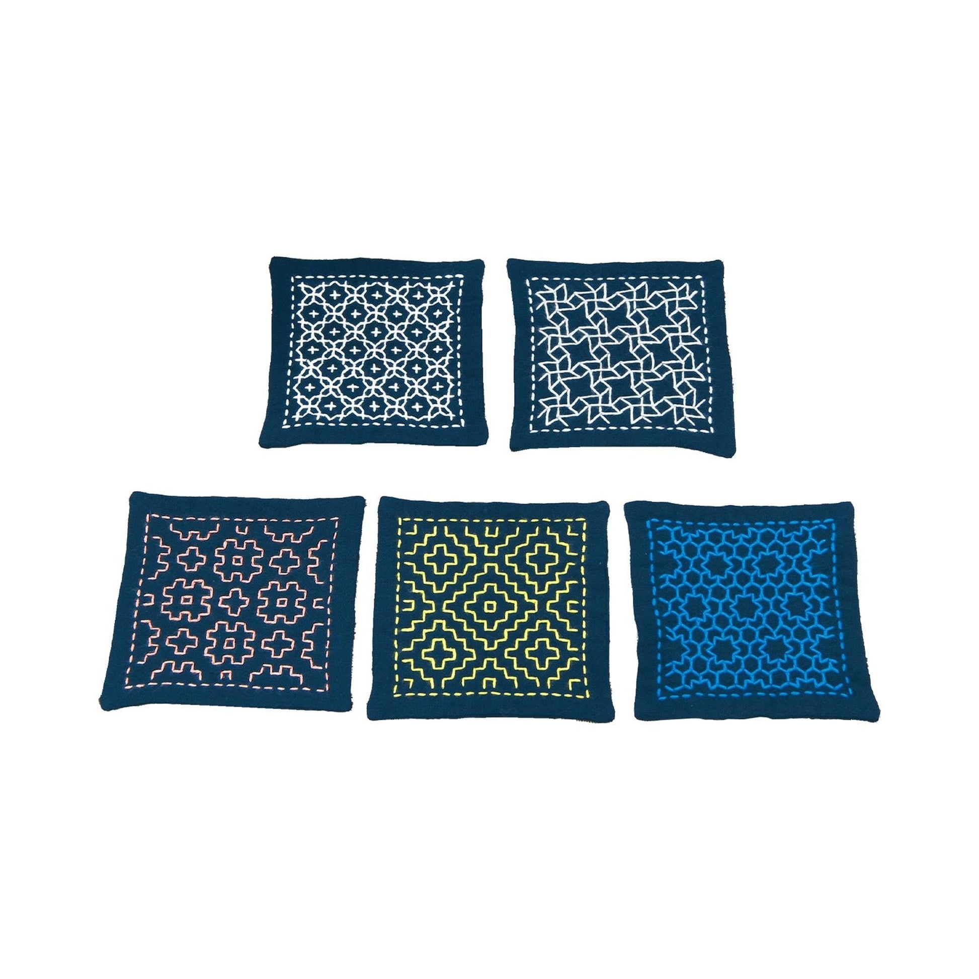 five square cushions with different patterns and designs, including a white and black geometric pattern, a blue and white geometric pattern, a pink and white geometric pattern, a yellow and black geometric pattern, and a blue and white geometric pattern.