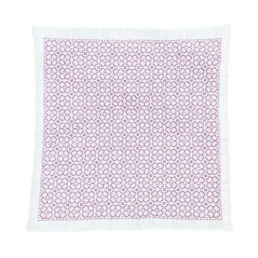 a square-shaped fabric with a repeating pattern of pink flowers on a white background.