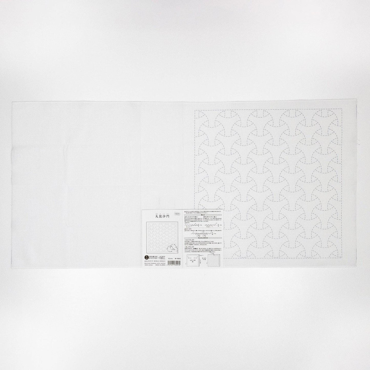 The image is a white sheet of paper with a repeating pattern of geometric shapes, such as a tessellation.