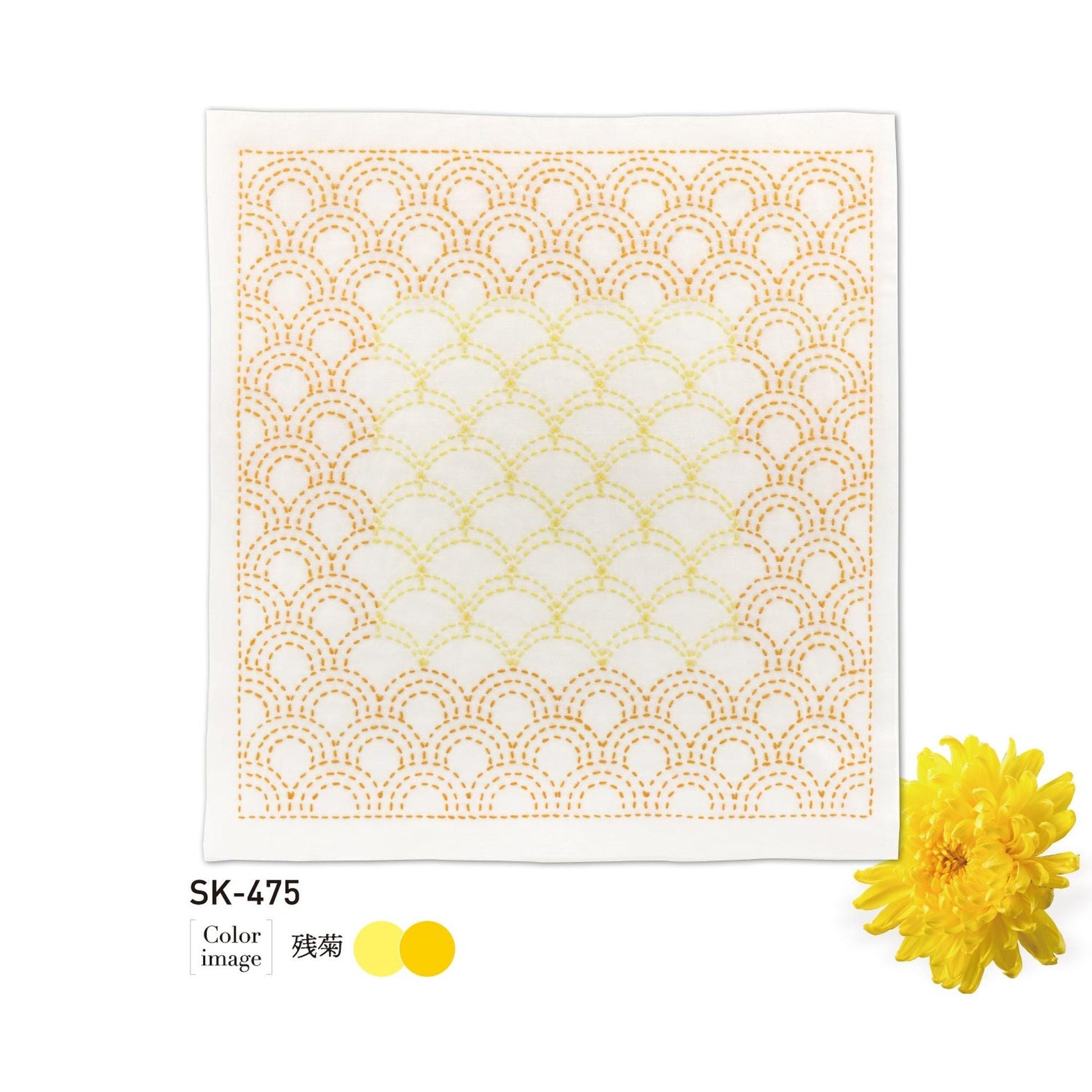 a square piece of fabric with a repeating pattern of yellow and white circles, resembling a wave or a mandala design. The fabric appears to be white, and there is a single yellow flower placed next to it.