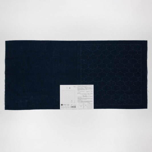 a dark blue fabric with a white label attached to it, placed against a white background.