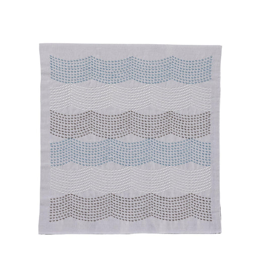 a gray fabric with a wavy pattern of small circles or dots arranged in a repeating diagonal line across the fabric.