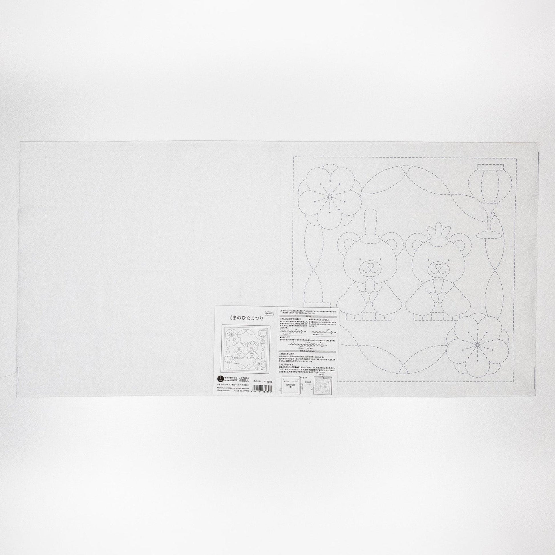 The image is a white sheet of paper with a black and white line drawing of two teddy bears and some flowers.