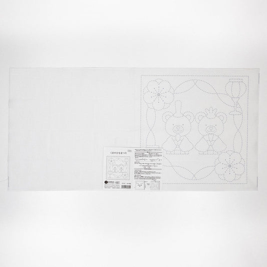 The image is a white sheet of paper with a black and white line drawing of two teddy bears and some flowers.