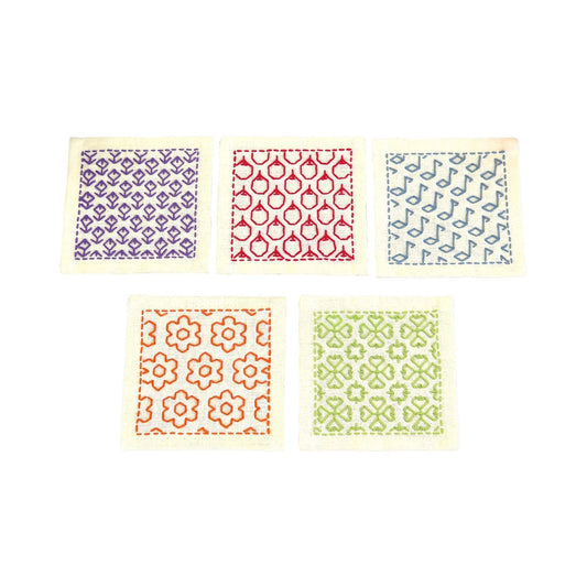 five square pieces of fabric with different patterns and colors, arranged in a row.